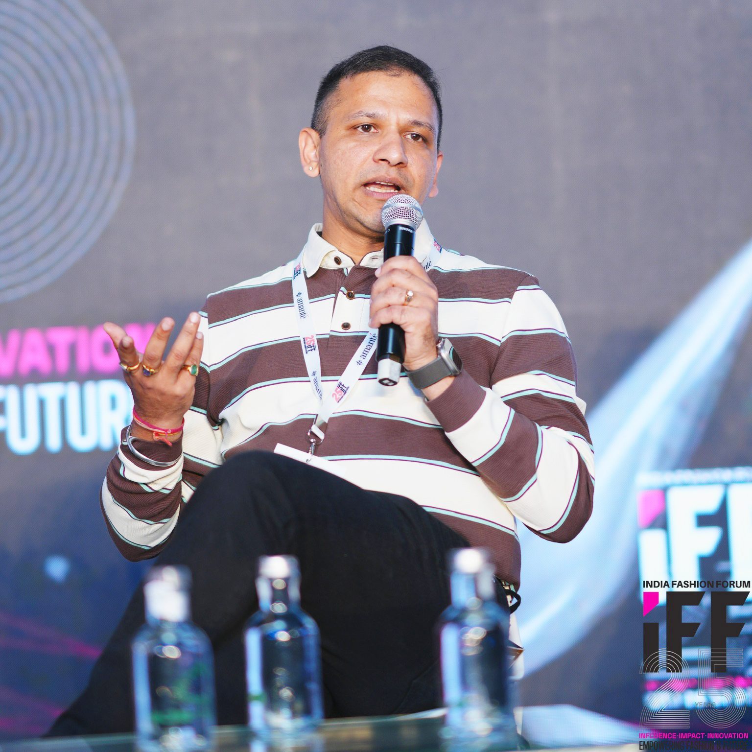 Akhil Jain speaking on stage at India Fashion Forum